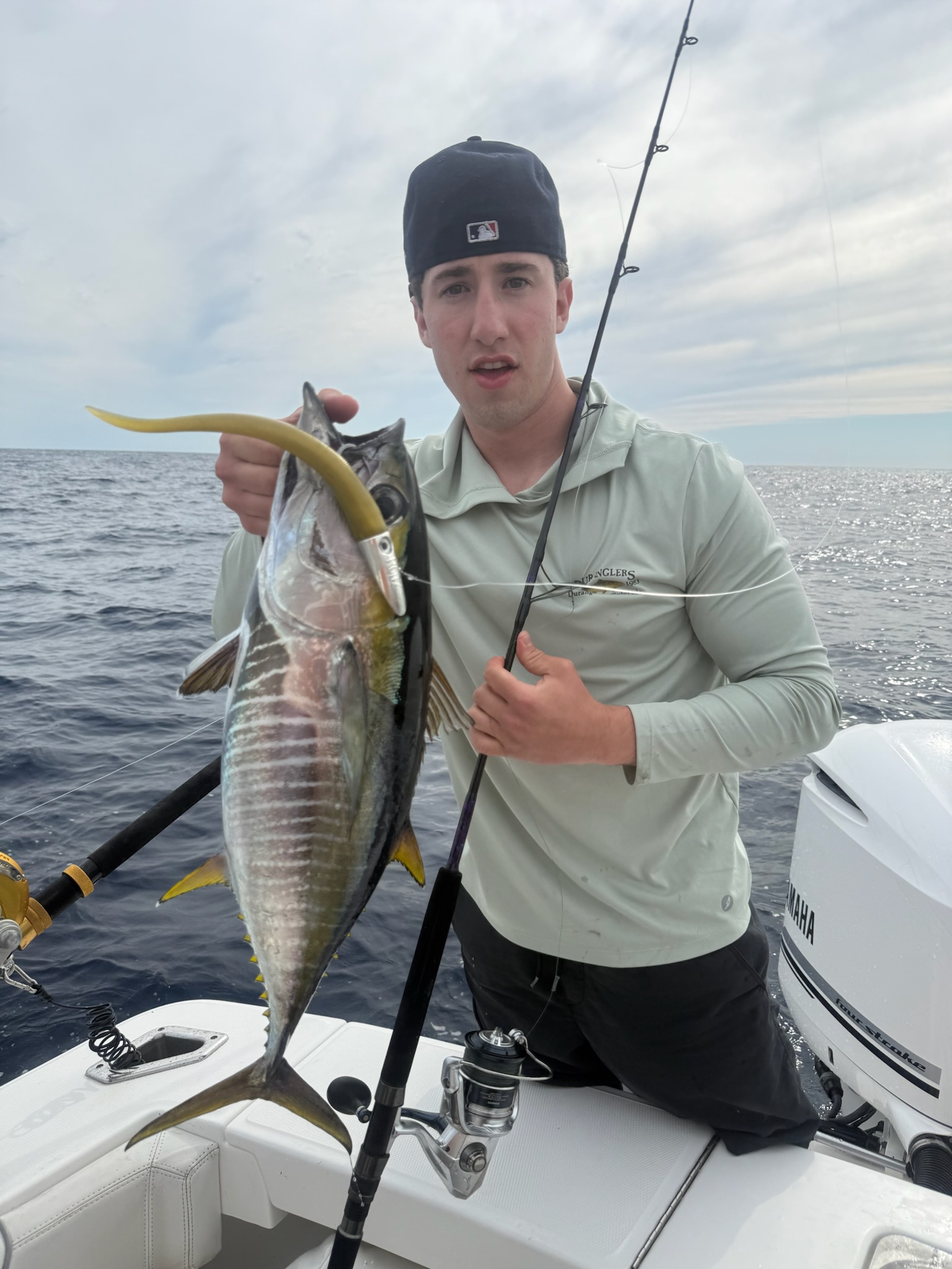 Angler with yellowfin tuna and rod