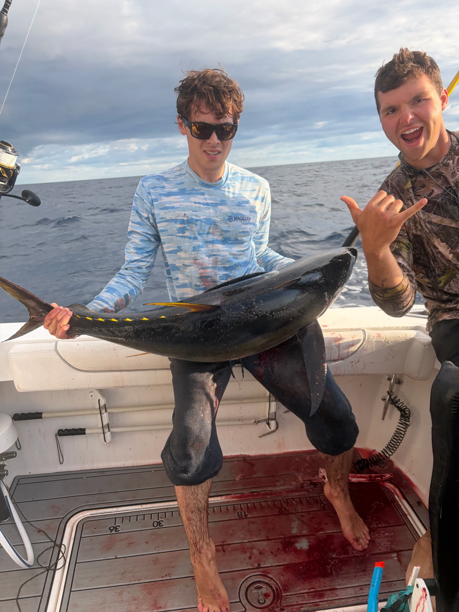 Two anglers with yellowfin tuna on deck