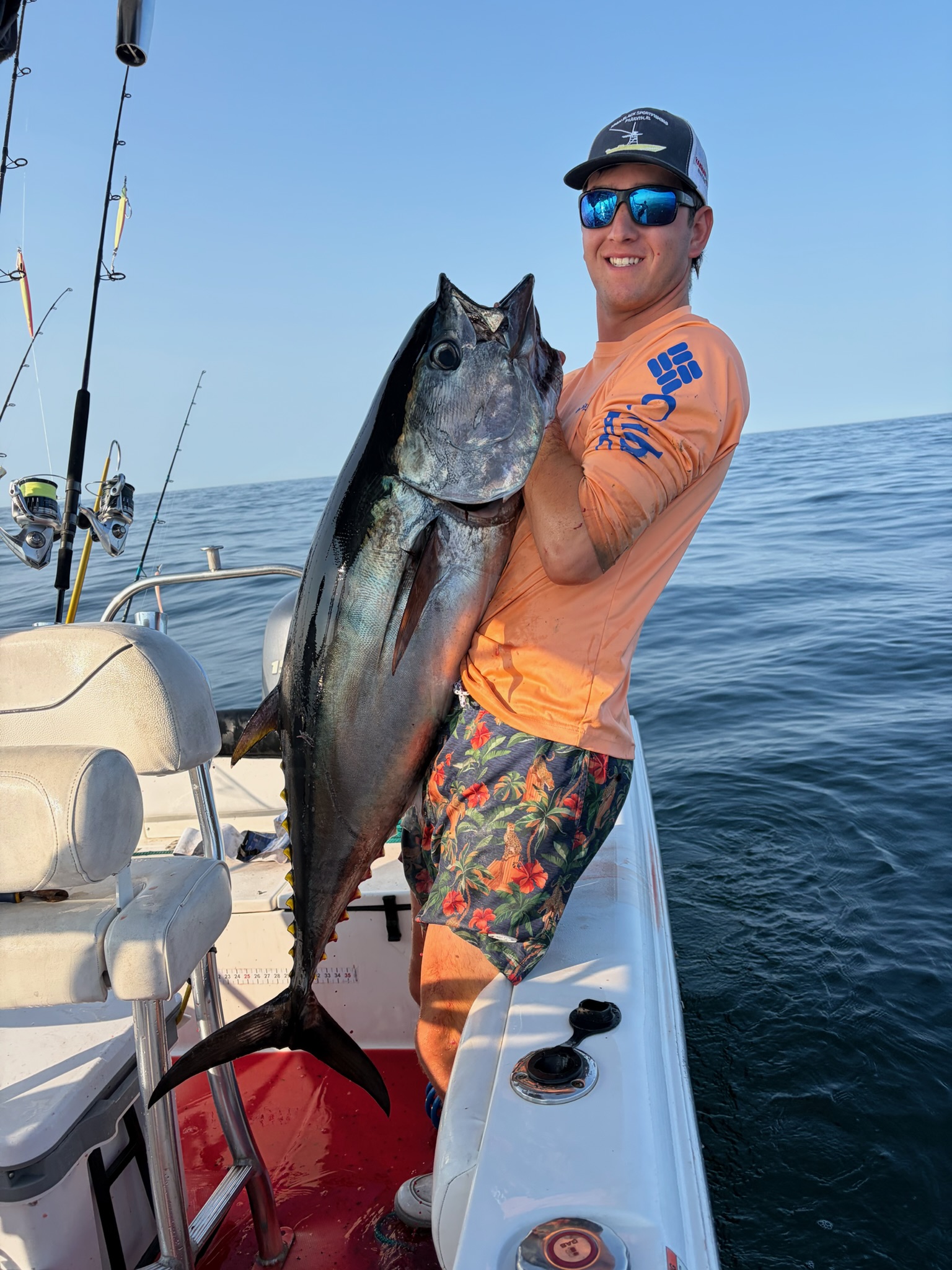 Angler holding large bluefin tuna on deck