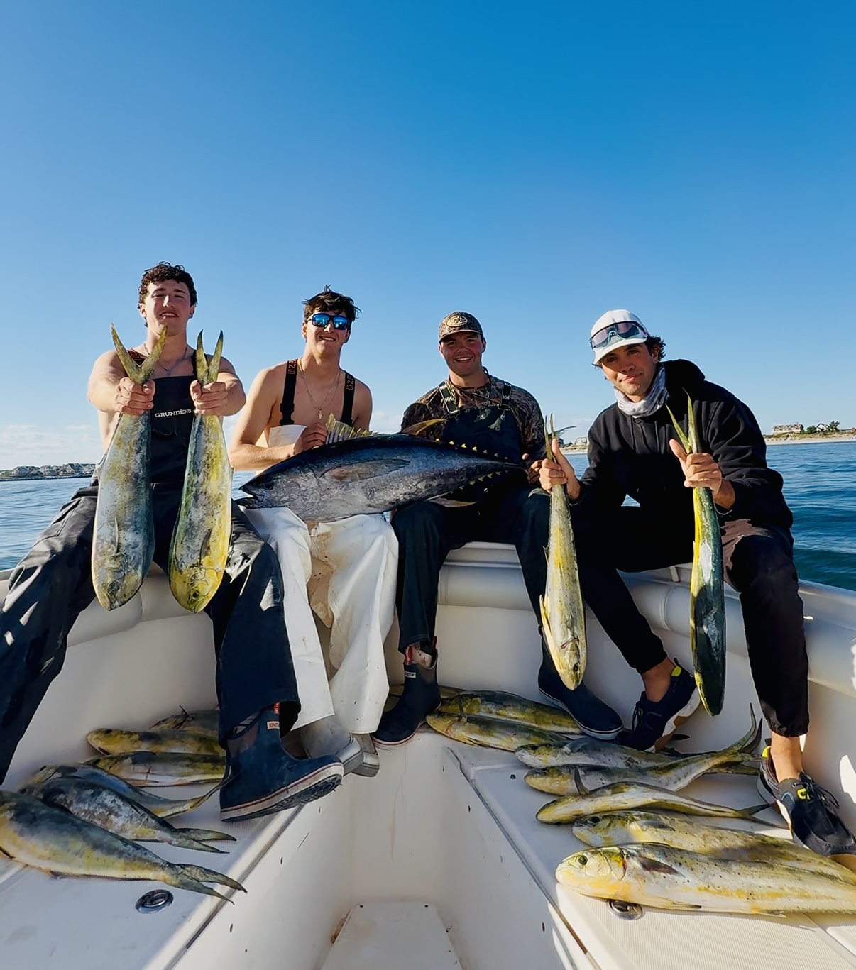 Four anglers with a thresher shark