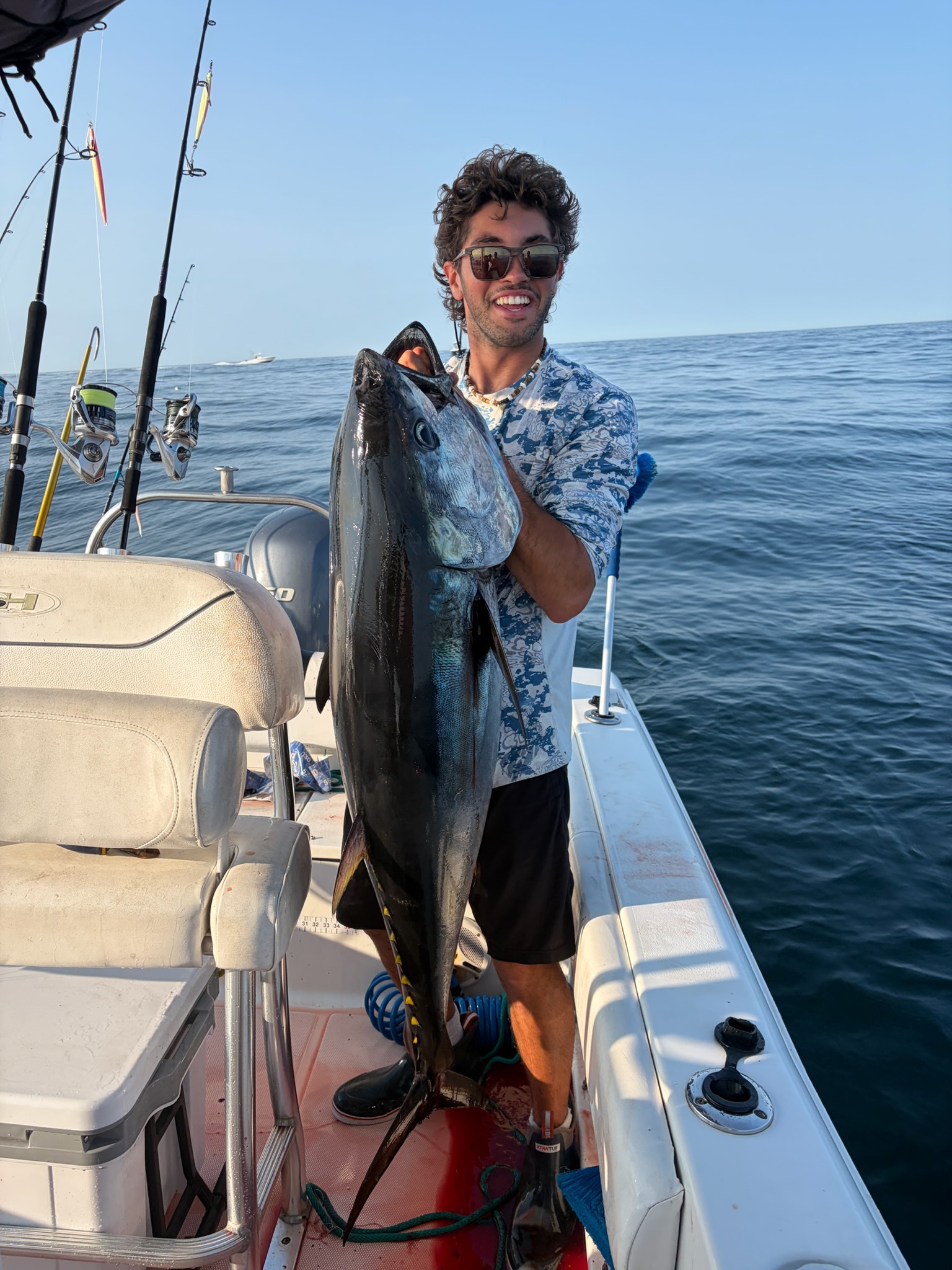 Angler holding bluefin tuna with sunglasses