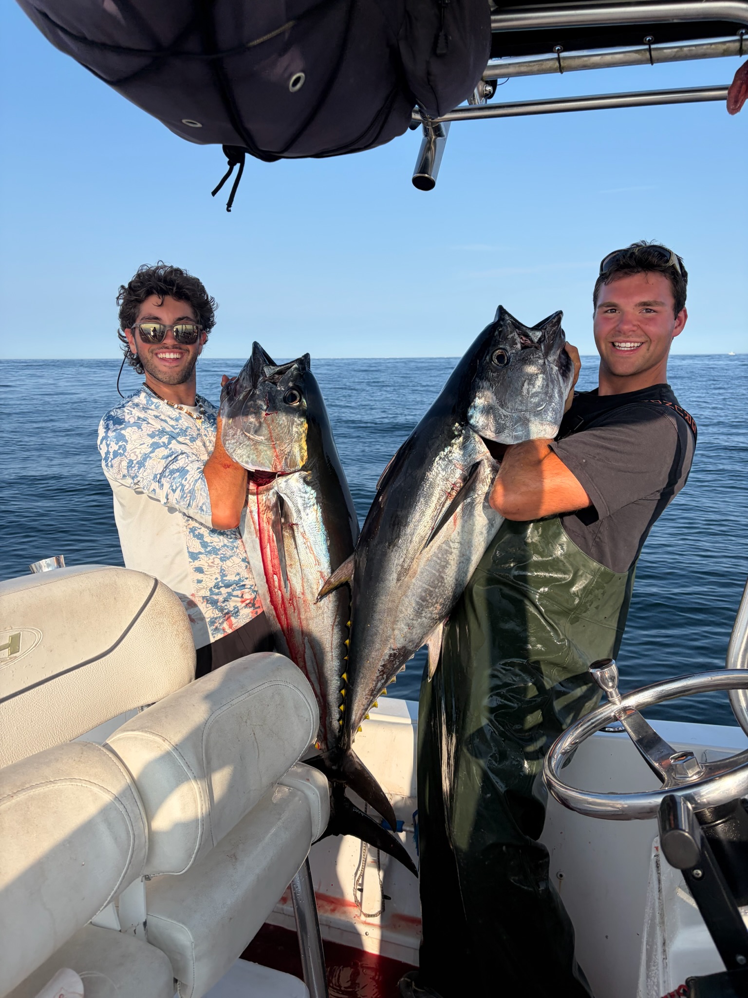 Two anglers each holding bluefin tuna