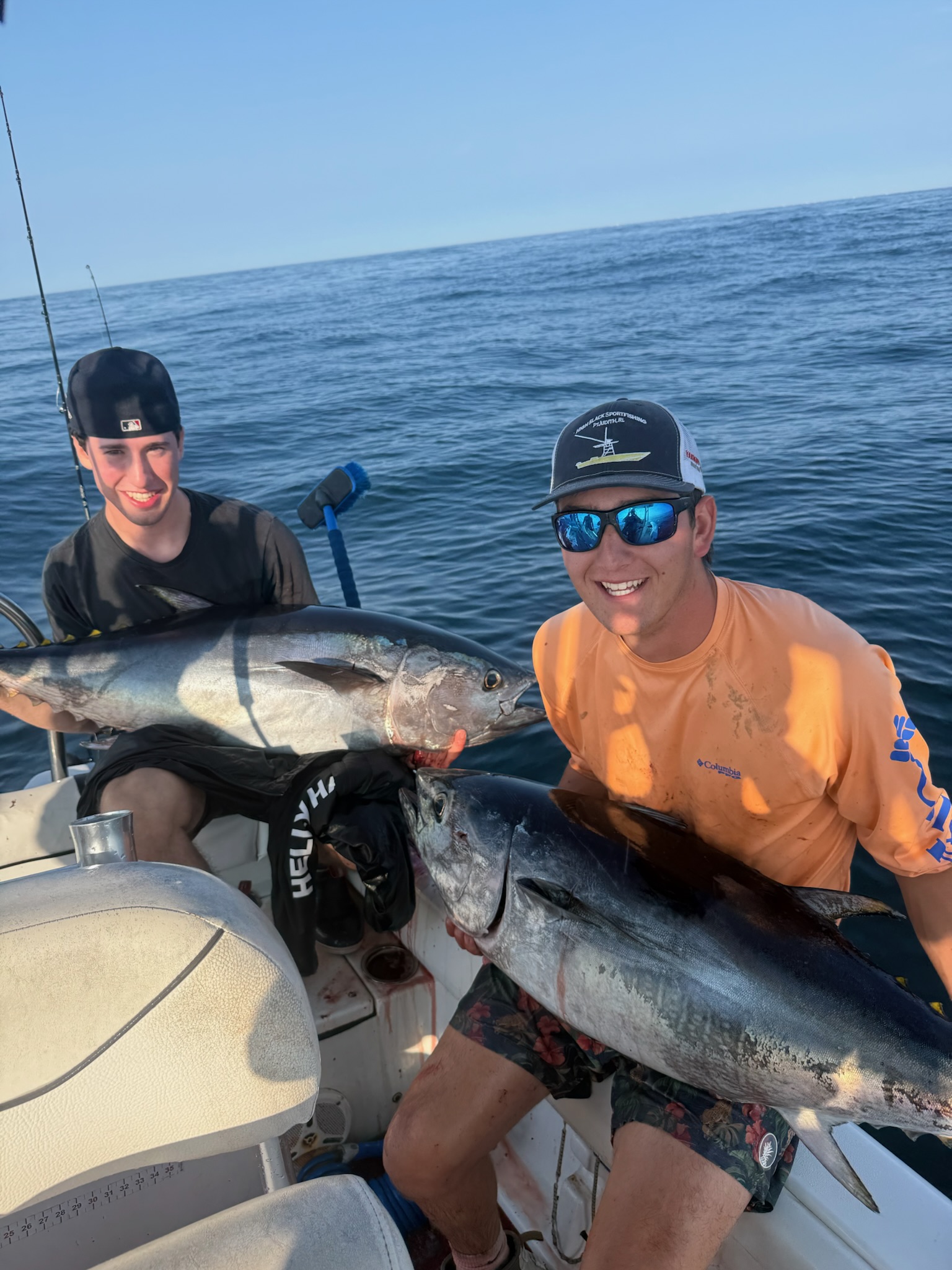 Two anglers with pair of bluefin tuna on deck
