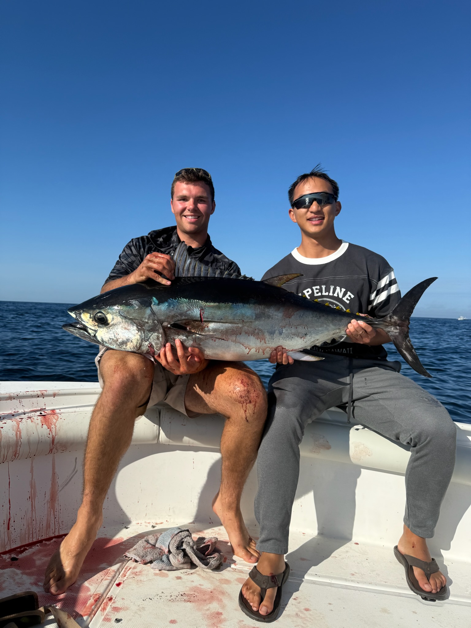 Two anglers holding large bluefin tuna together
