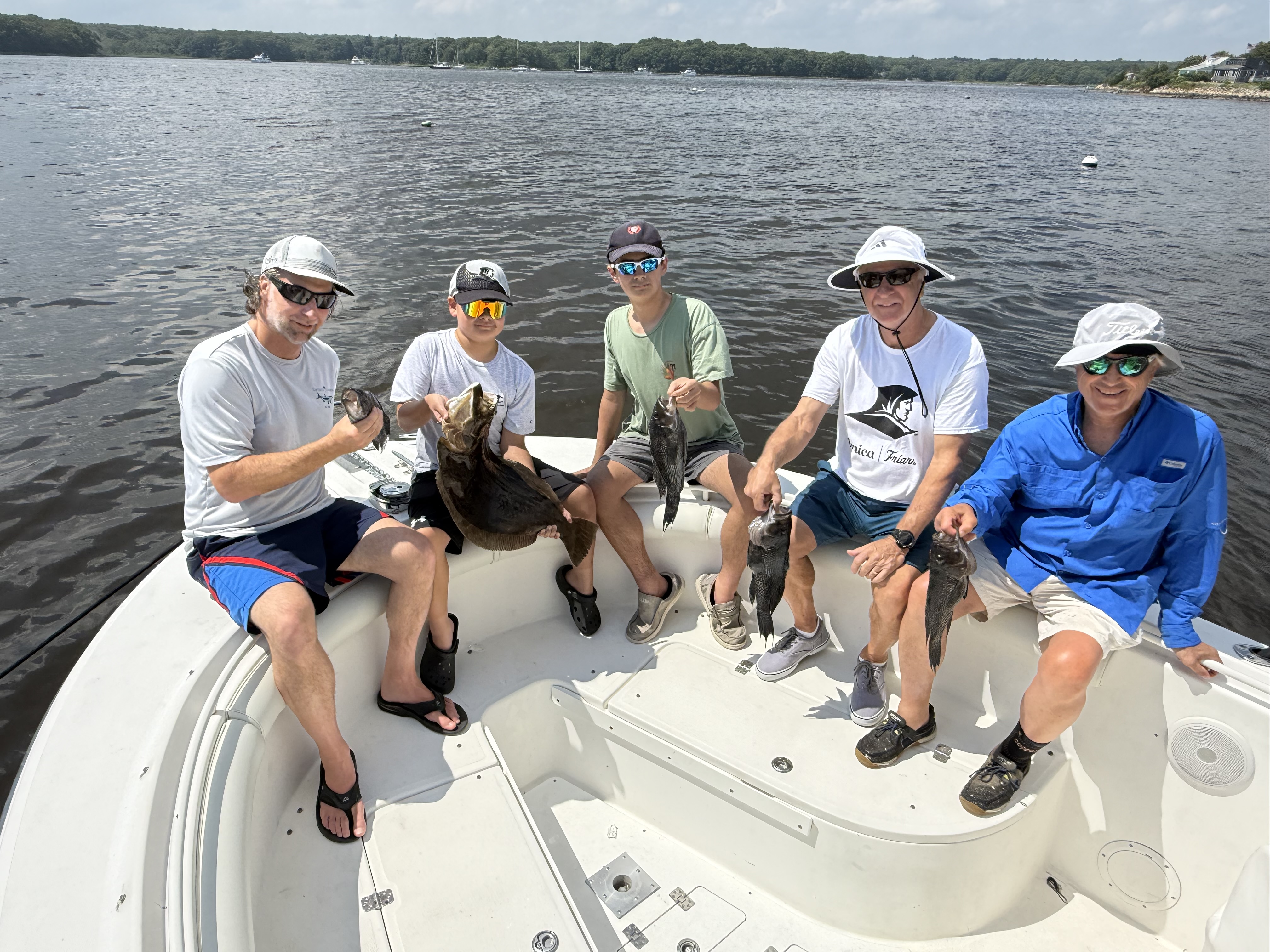 Five anglers on bow with fluke and sea bass catch