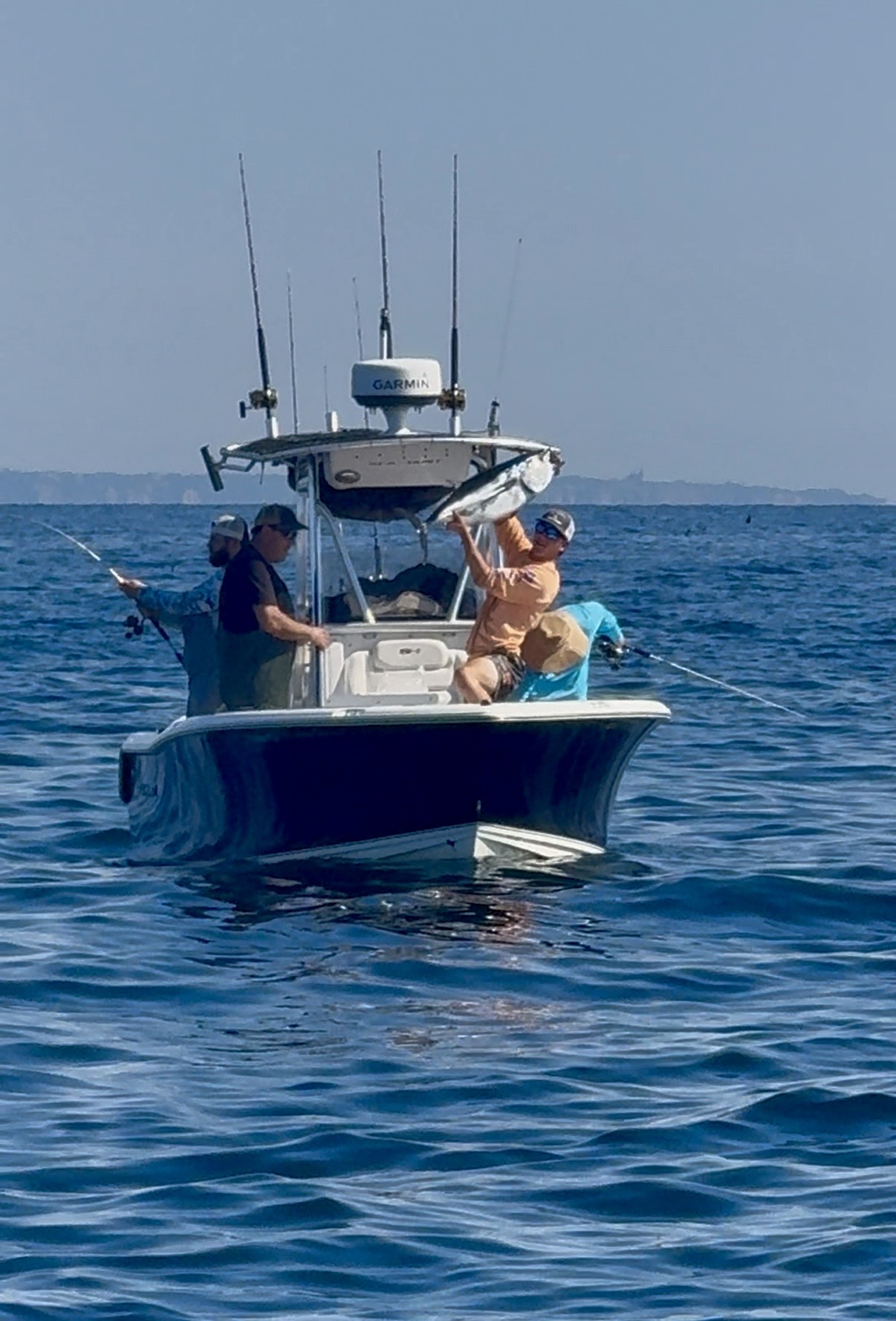 Sea Hunt center console on water with crew fishing