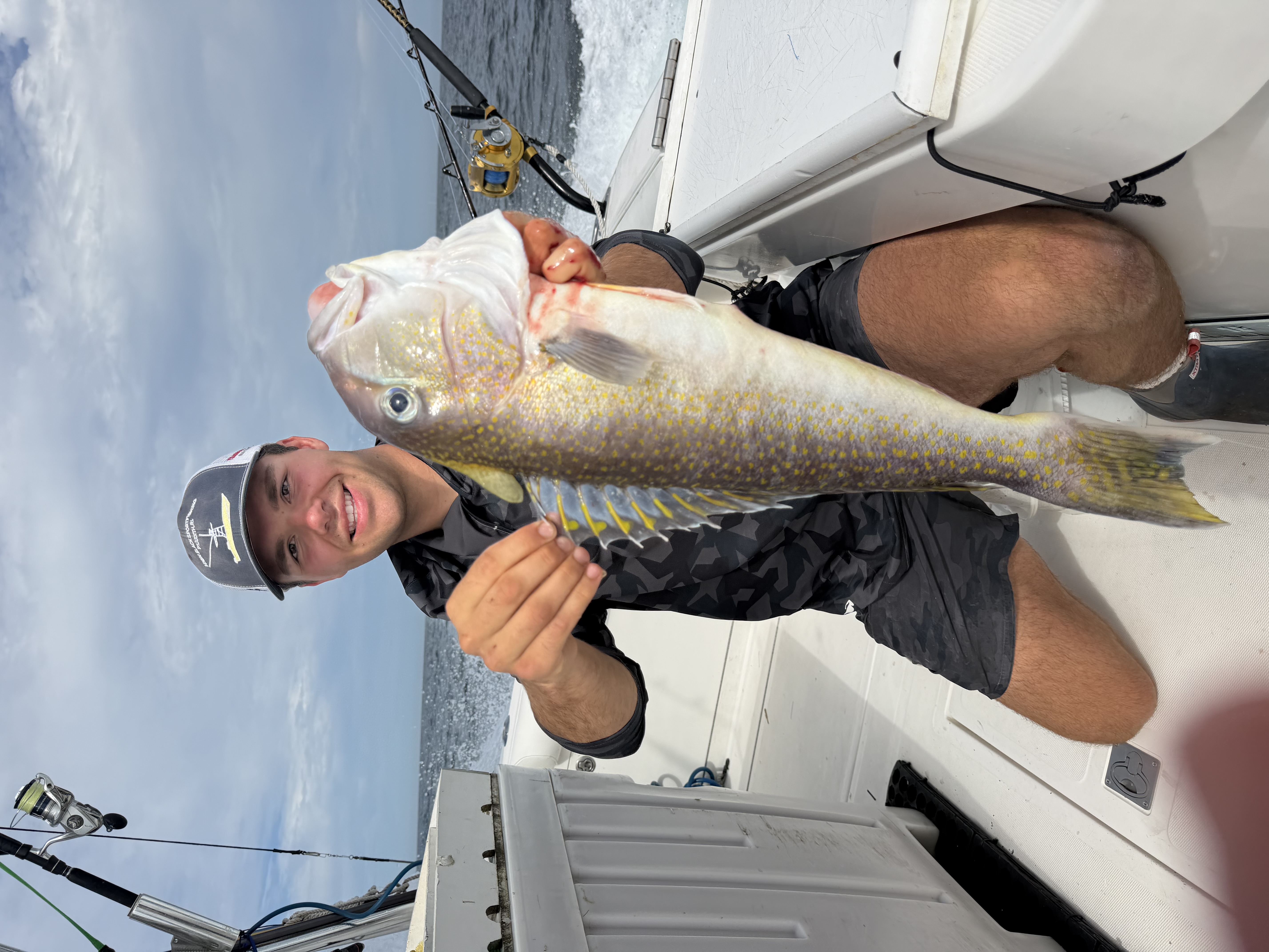 Angler holding golden tilefish on boat