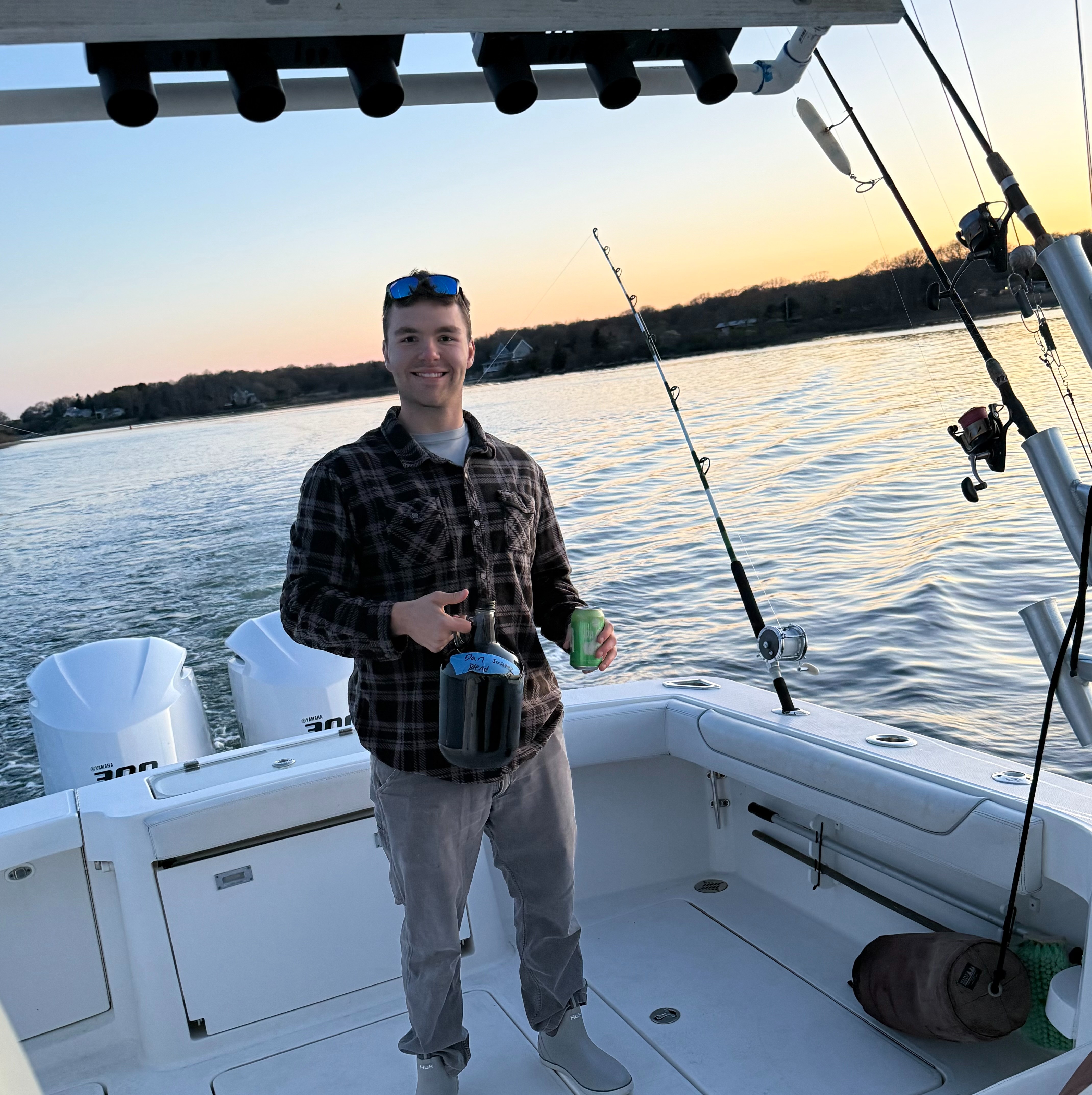 Angler on boat at sunset